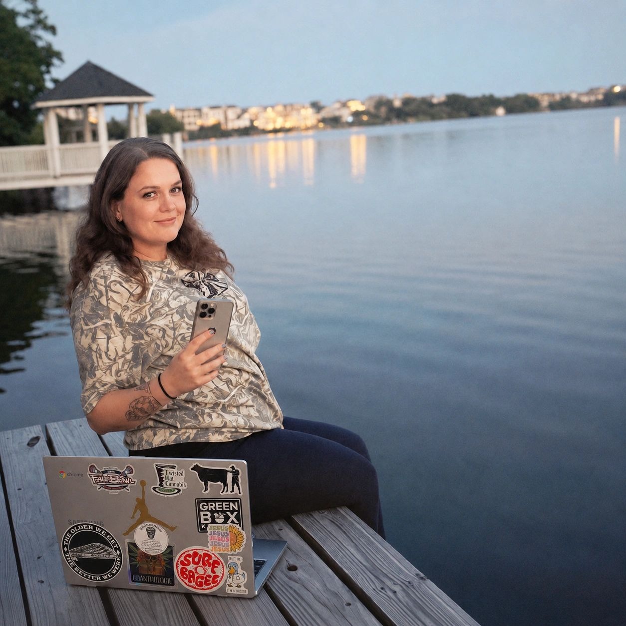 Mackenzie Reynolds sitting beside the water with her laptop and phone